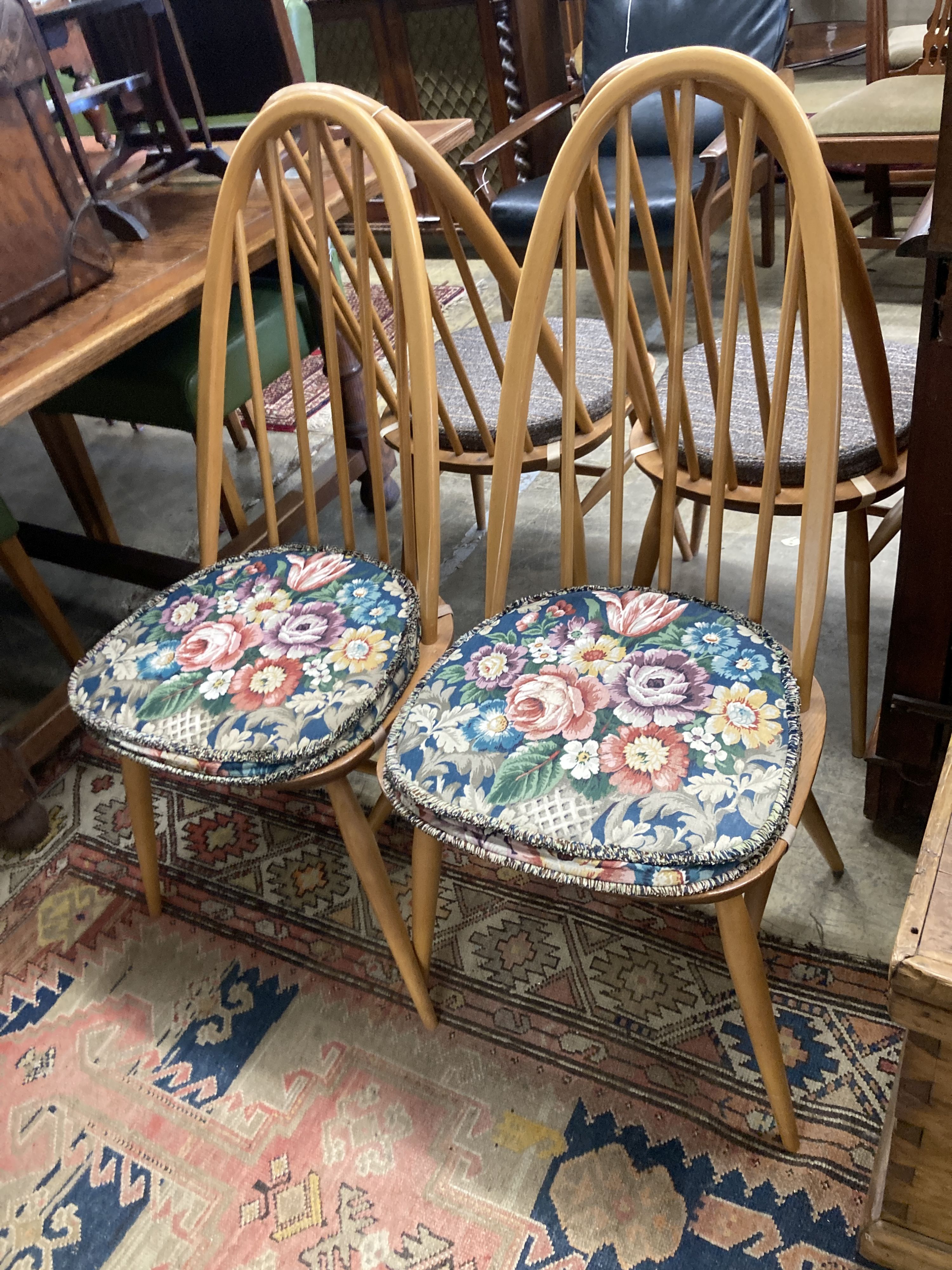 A set of four Ercol light beech comb back Windsor dining chairs